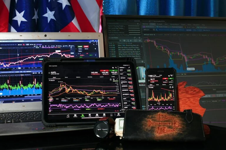 Investment trading screens showing live US stock market data and portfolio charts for American expat investment strategy and portfolio diversification in Thailand