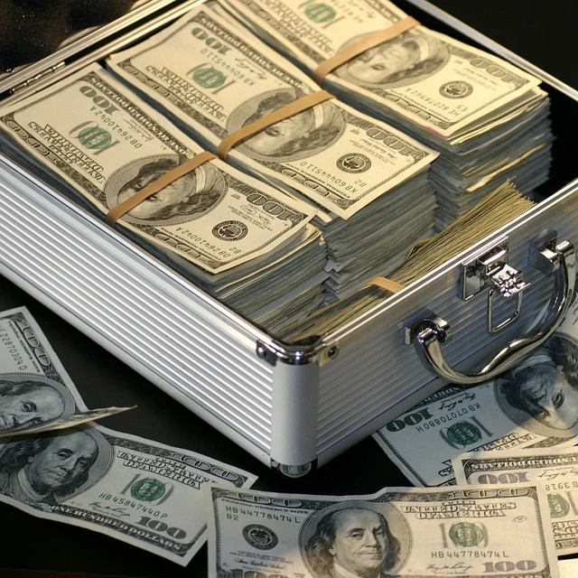 Briefcase filled with stacked US dollar bills representing secured wealth through legal asset protection structures and strategies for American expats in Thailand