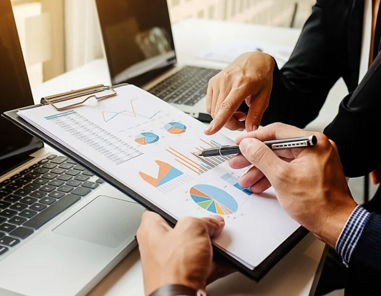 Financial advisor and American expat client reviewing investment charts and wealth management strategy in Thailand – Ken Brown Financial Consultant comprehensive services