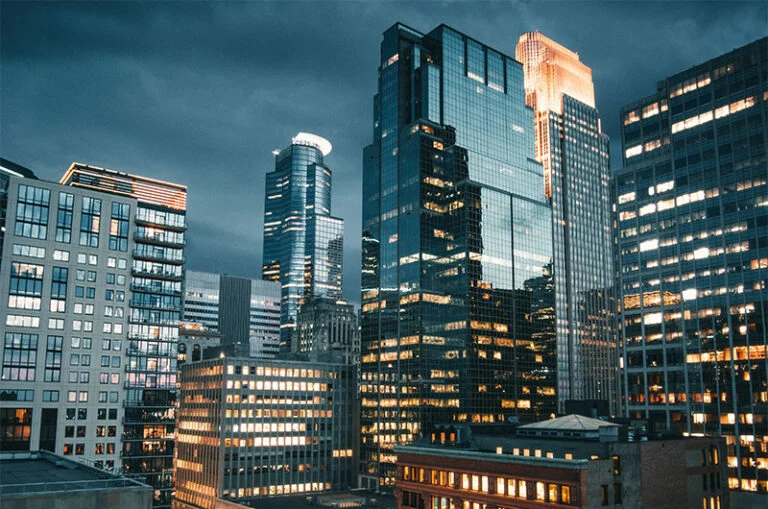 International financial district skyline at night representing corporate compliance, governance standards, and business services for American expats running companies in Thailand