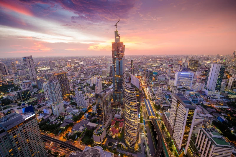 Bangkok skyline at golden sunset featuring the Mahanakhon tower – prime Thai real estate landscape for American expats investing in property in Thailand