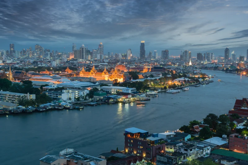 Bangkok Grand Palace and Chao Phraya River at dusk showing prime Thai property investment locations and real estate opportunities for American expats